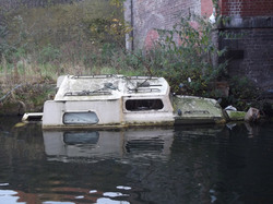 Old boat part sunk in stretford canal manchester