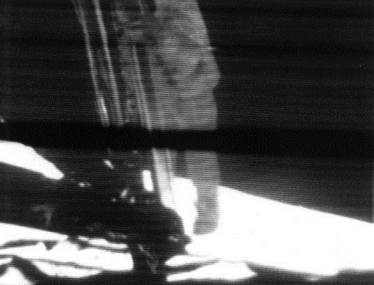 A still frame from a video transmission, taken moments before Neil Armstrong became the first human to step onto the surface of the Moon, at 02:56 UTC on 21 July 1969. An estimated 500 million people worldwide watched this event, the largest television audience for a live broadcast at that time.
