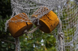 Small buoys in a fish net decor
