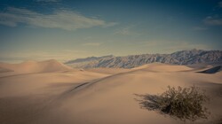 Lines of dunes disappear into the distant mountains in Death Valley National Park, California.