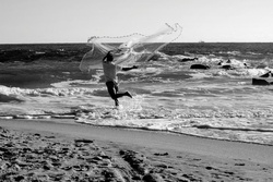 Fisherman casting his net for bait fish on the beach at Florida, USA